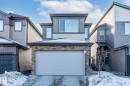 View of front of property with stone siding, driveway, and a garage - 217 Larch Crescent, Leduc, AB  - Outdoor With Exterior 