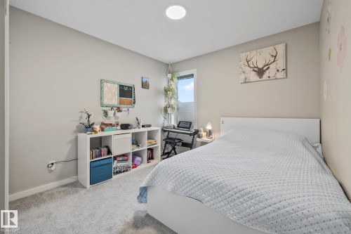 Bedroom featuring carpet floors and baseboards - 217 Larch Crescent, Leduc, AB - Indoor Photo Showing Bedroom