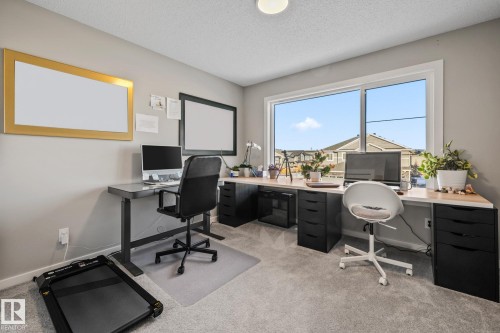 Office with light colored carpet and a textured ceiling - 217 Larch Crescent, Leduc, AB - Indoor Photo Showing Office