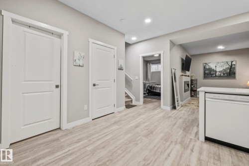 Corridor with stairs, light wood finished floors, and recessed lighting - 217 Larch Crescent, Leduc, AB - Indoor Photo Showing Other Room
