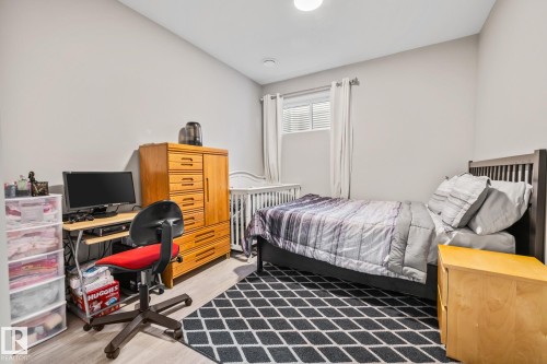 Bedroom featuring light wood finished floors and an office area - 217 Larch Crescent, Leduc, AB - Indoor Photo Showing Bedroom