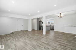 Unfurnished living room with recessed lighting, light wood-type flooring, and a chandelier - 