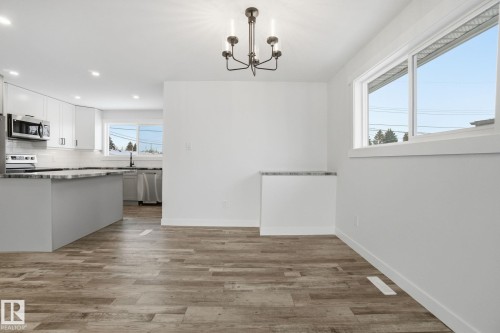 Unfurnished dining area with light wood-style flooring, a chandelier, and recessed lighting - 7112 132 Avenue, Edmonton, AB - Indoor Photo Showing Kitchen With Upgraded Kitchen