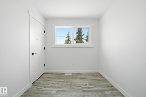 Unfurnished room featuring light wood finished floors and baseboards - 7112 132 Avenue, Edmonton, AB - Indoor Photo Showing Other Room