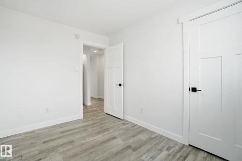 Unfurnished bedroom with light wood-type flooring and baseboards - 7112 132 Avenue, Edmonton, AB - Indoor Photo Showing Other Room
