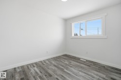 Unfurnished room featuring wood finished floors and baseboards - 