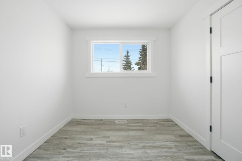 Unfurnished room featuring light wood-style flooring and baseboards - 7112 132 Avenue, Edmonton, AB - Indoor Photo Showing Other Room