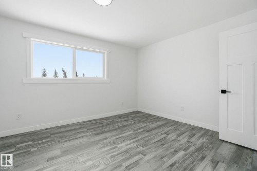 Empty room with wood finished floors - 7112 132 Avenue, Edmonton, AB - Indoor Photo Showing Other Room