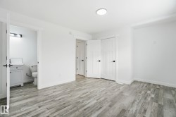 Unfurnished bedroom with a closet, light wood-style flooring, and ensuite bathroom - 
