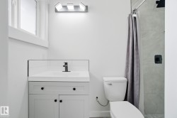 Bathroom featuring a shower stall and vanity - 