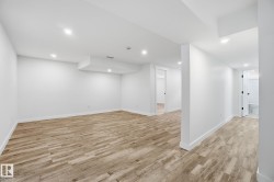 Finished below grade area featuring light wood finished floors and recessed lighting - 