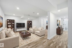Living area featuring light wood-type flooring and recessed lighting - 
