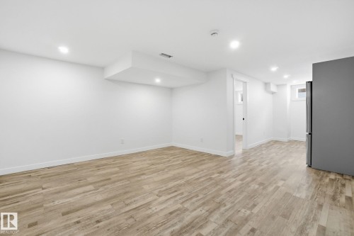 Finished below grade area featuring light wood-style flooring and recessed lighting - 7112 132 Avenue, Edmonton, AB - Indoor