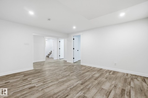 Unfurnished room featuring light wood-type flooring, stairway, and recessed lighting - 7112 132 Avenue, Edmonton, AB - Indoor Photo Showing Other Room