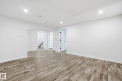 Unfurnished room featuring light wood-type flooring, stairway, and recessed lighting - 