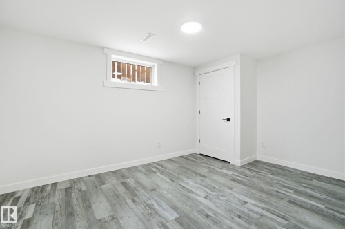 Unfurnished room featuring light wood finished floors and baseboards - 7112 132 Avenue, Edmonton, AB - Indoor Photo Showing Other Room