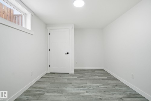 Unfurnished room with light wood-style flooring and baseboards - 7112 132 Avenue, Edmonton, AB - Indoor Photo Showing Other Room