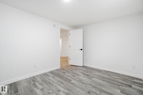 Spare room featuring wood finished floors and baseboards - 7112 132 Avenue, Edmonton, AB - Indoor Photo Showing Other Room