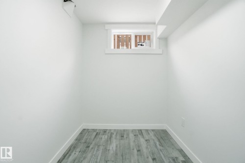 Empty room with baseboards and light wood-type flooring - 7112 132 Avenue, Edmonton, AB - Indoor Photo Showing Other Room