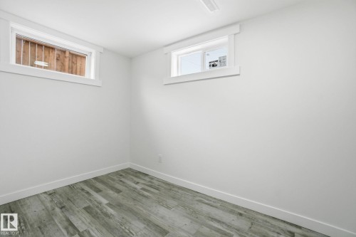 Basement with baseboards and wood finished floors - 7112 132 Avenue, Edmonton, AB - Indoor Photo Showing Other Room