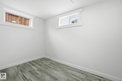 Basement with baseboards and wood finished floors - 