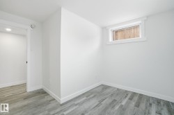 Empty room featuring baseboards and light wood-style flooring - 