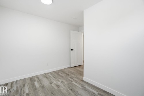 Spare room with light wood-style floors and baseboards - 7112 132 Avenue, Edmonton, AB - Indoor Photo Showing Other Room