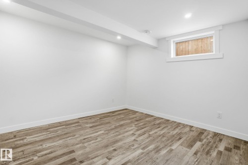 Below grade area with recessed lighting and wood finished floors - 7112 132 Avenue, Edmonton, AB - Indoor Photo Showing Other Room