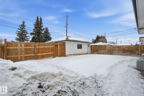 Snowy yard featuring a fenced backyard and a gate - 7112 132 Avenue, Edmonton, AB - Outdoor