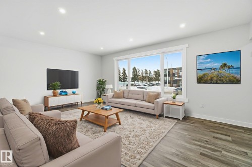 Living area featuring wood finished floors and recessed lighting - 7112 132 Avenue, Edmonton, AB - Indoor Photo Showing Living Room