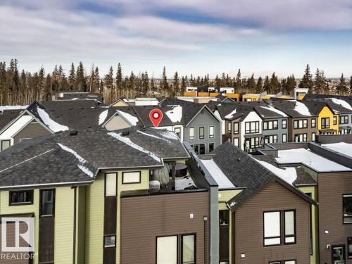 View of front facade featuring a residential view and a shingled roof - 125 1304 Rutherford Road, Edmonton, AB - Outdoor