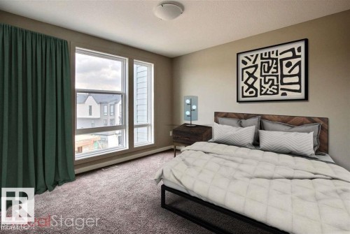 Bedroom with carpet floors and a textured ceiling - 125 1304 Rutherford Road, Edmonton, AB - Indoor Photo Showing Bedroom