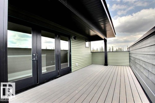 Wooden deck with french doors - 125 1304 Rutherford Road, Edmonton, AB - Outdoor With Deck Patio Veranda With Exterior
