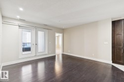 Spare room featuring dark wood-style floors, recessed lighting, and a textured ceiling - 