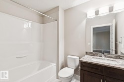 Full bath featuring vanity, shower / tub combination, a textured ceiling, and backsplash - 