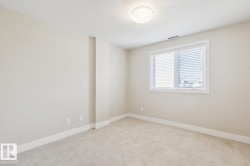 Unfurnished room featuring light carpet and a textured ceiling - 