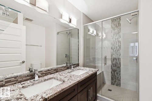 Bathroom with a stall shower and double vanity - 208 1350 Windermere Way, Edmonton, AB - Indoor Photo Showing Bathroom