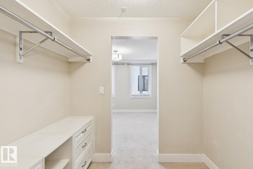 Spacious closet with light carpet - 208 1350 Windermere Way, Edmonton, AB - Indoor With Storage