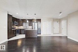 Kitchen featuring dark brown cabinets, stainless steel appliances, decorative light fixtures, recessed lighting, and a center island - 