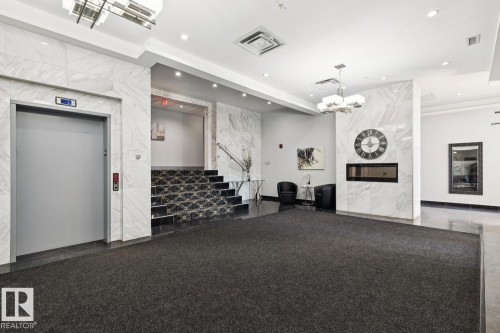 Common area with stairs, recessed lighting, and tile walls - 208 1350 Windermere Way, Edmonton, AB - Indoor Photo Showing Other Room