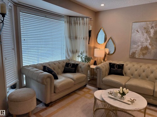 Living area featuring a textured ceiling and recessed lighting - 11 15128 22 Street, Edmonton, AB - Indoor Photo Showing Living Room