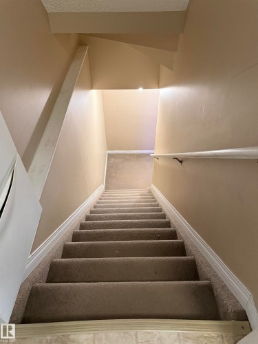 Stairway with carpet floors and baseboards - 11 15128 22 Street, Edmonton, AB - Indoor Photo Showing Other Room