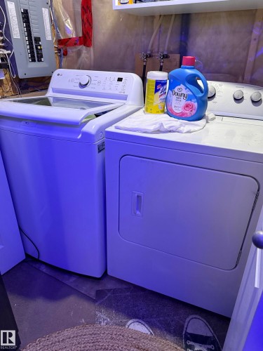 Washroom with electric panel and washer and dryer - 11 15128 22 Street, Edmonton, AB - Indoor Photo Showing Laundry Room