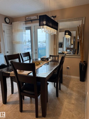 Dining space with a textured ceiling - 11 15128 22 Street, Edmonton, AB - Indoor Photo Showing Dining Room