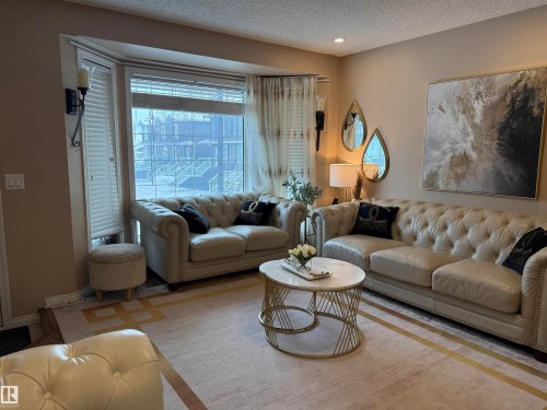 Living area featuring a textured ceiling and recessed lighting - 11 15128 22 Street, Edmonton, AB - Indoor Photo Showing Living Room