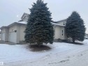 View of snowy exterior featuring stucco siding and a garage - 6562 158 Avenue, Edmonton, AB  - Outdoor 