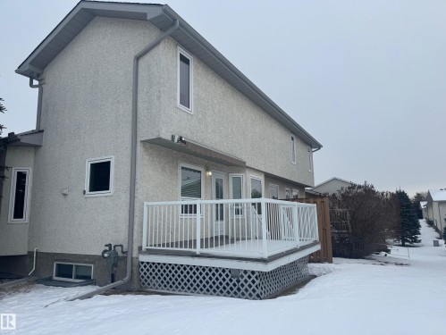 Snow covered property with stucco siding and a deck - 6562 158 Avenue, Edmonton, AB - Outdoor With Deck Patio Veranda With Exterior