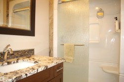 Full bath with tasteful backsplash, vanity, and a stall shower - 