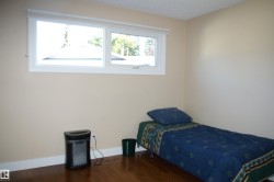 Bedroom with wood finished floors and a textured ceiling - 