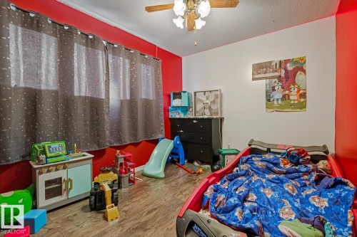 Bedroom featuring a textured ceiling, ceiling fan, and wood finished floors - 11516 152A Avenue, Edmonton, AB - Indoor Photo Showing Bedroom